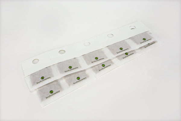 white sachets on hooks with predatory mites