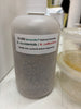 Bottle labeled with '25,000 Benemite Natural Enemies' on a white surface.