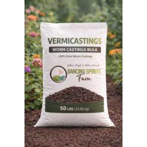 A 50 lb bag of Vermicastings Worm Castings Bulk by Dancing Spirits Farm, displayed on a bed of dark compost with blurred garden foliage in the background.